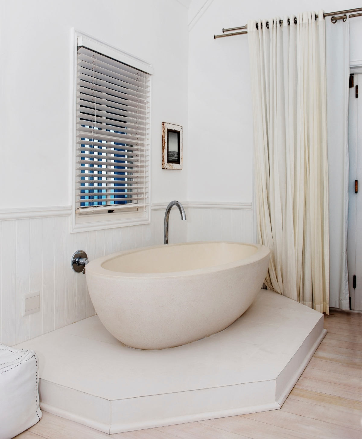 Beautiful white bathtub in the corner of a room